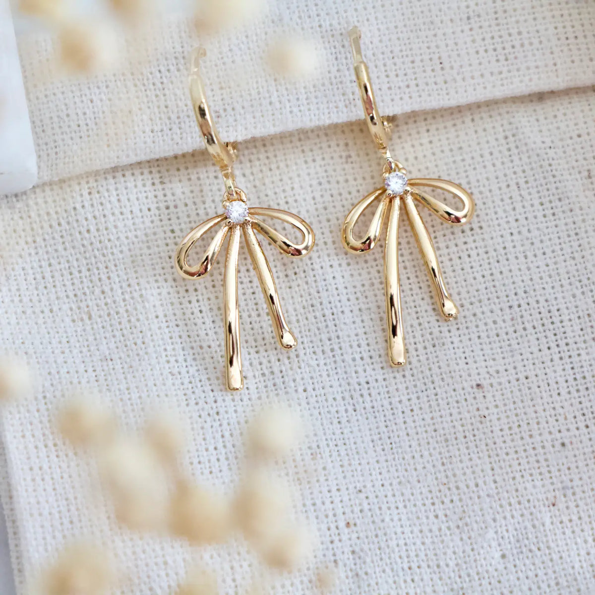 Gold Plated Bow Huggie Earrings by Mesa Blue