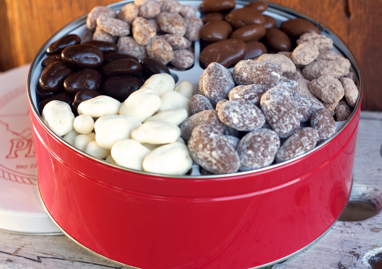 This candied pecan gift tin comes with: Milk Chocolate Pecans, Cinnamon Pecans, Praline Pecans, Dark Chocolate Pecans, Creamy White Pecans and Chocolate Toffee Pecans. This tin includes 3.5 lbs of candied pecans. 